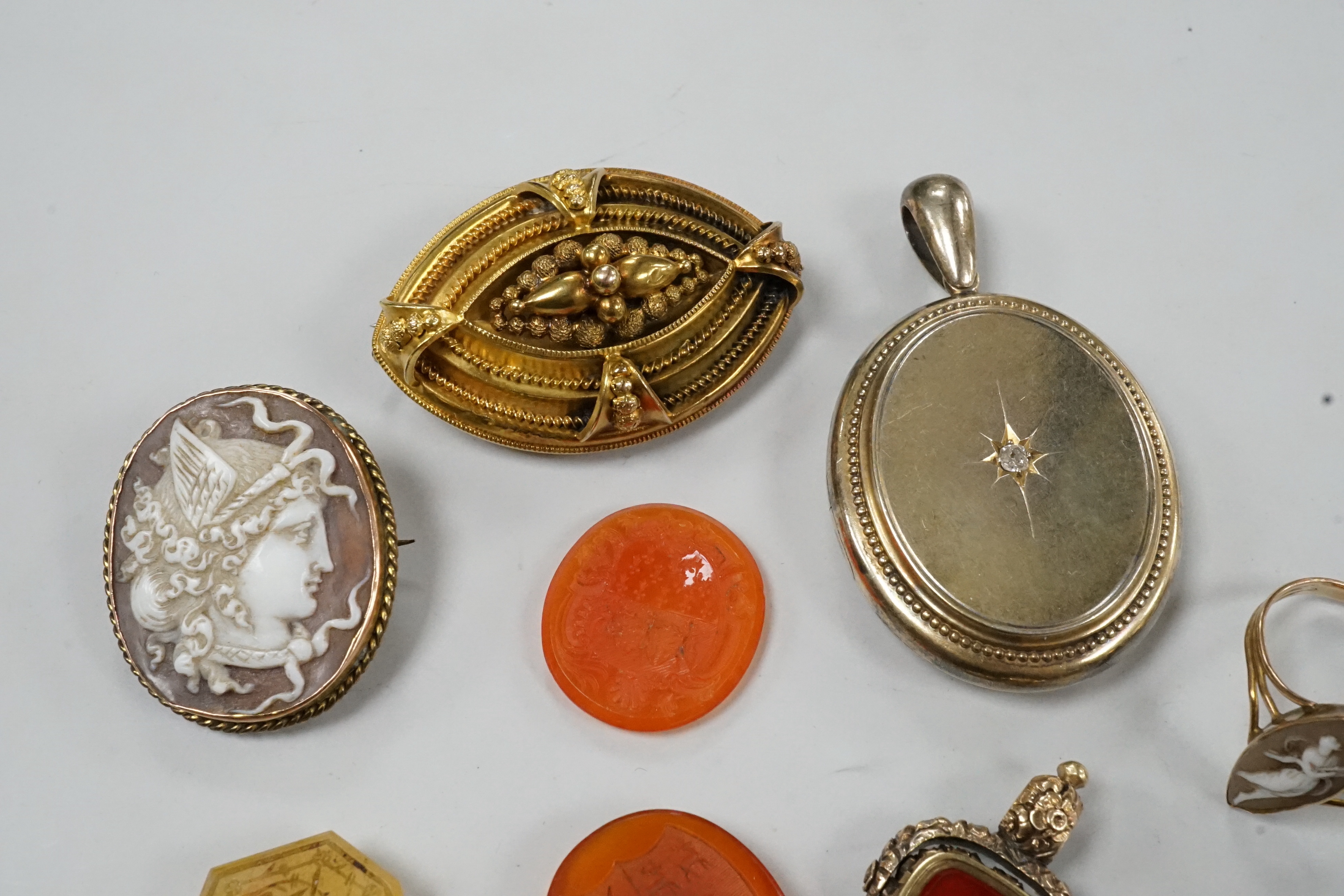 Assorted Victorian jewellery including cameo shell brooch and ring, diamond set locket, brooch, spinning fob seal and three unmounted carnelian intaglios.